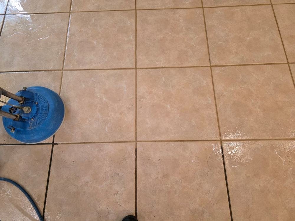 Rotary cleaning head on beige tile and grout