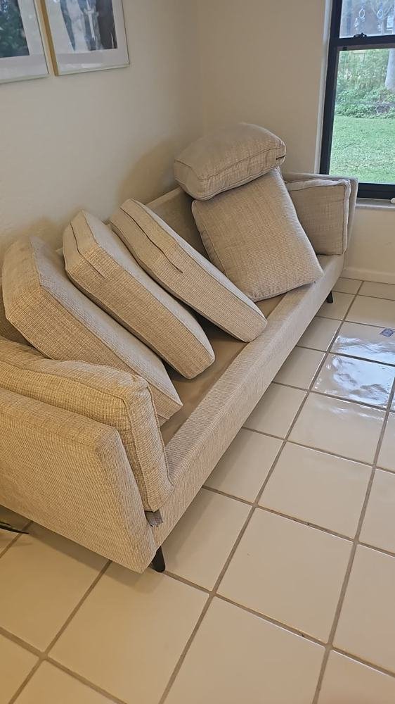 Cream sofa with cushions after deep upholstery cleaning