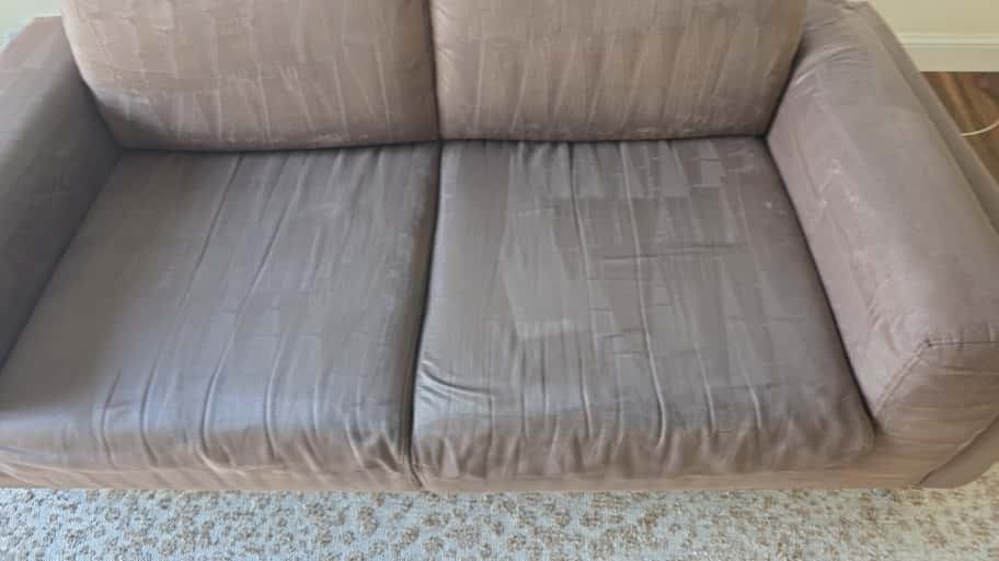 Gray sofa during upholstery steam cleaning