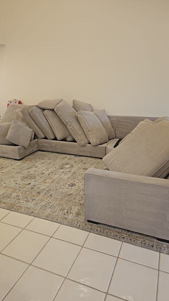 Sectional sofa with cushions lined up for upholstery cleaning