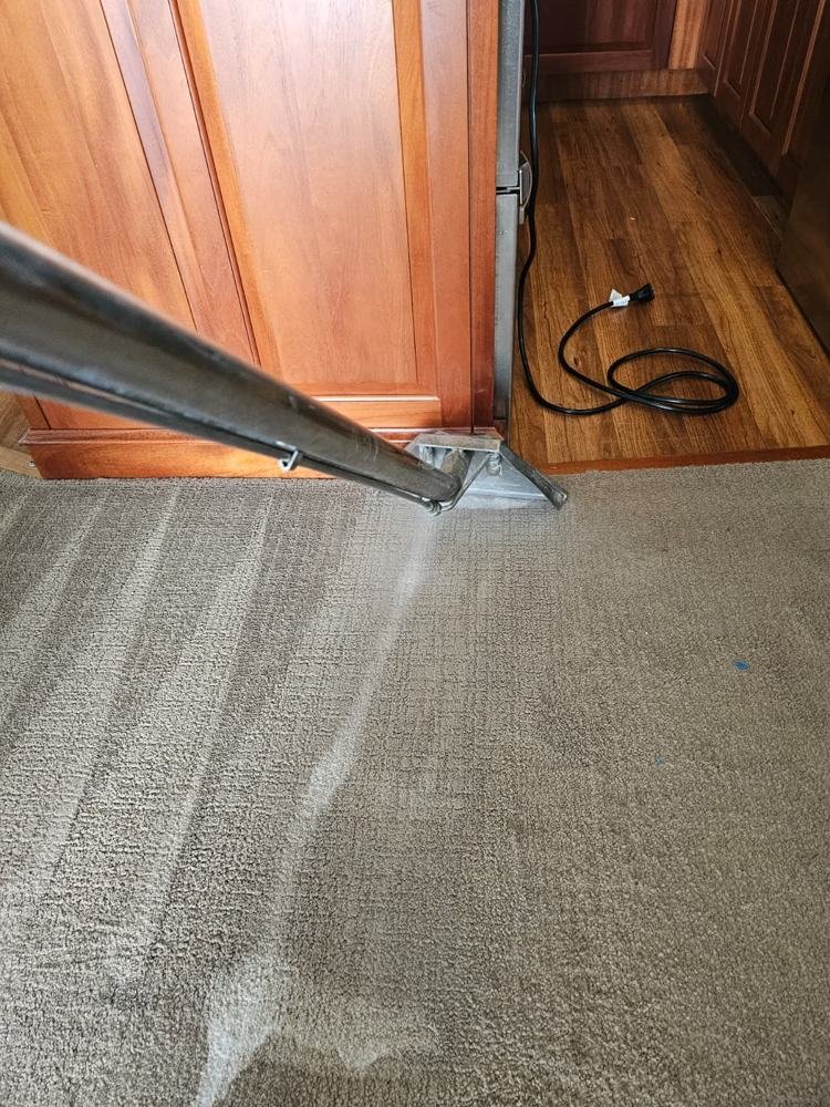 Steam cleaning wand along yacht carpet edge