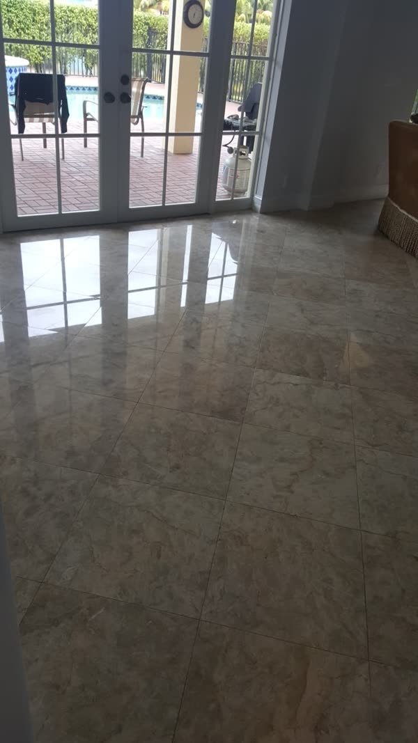 Polished beige marble floor with a glossy shine after marble polishing