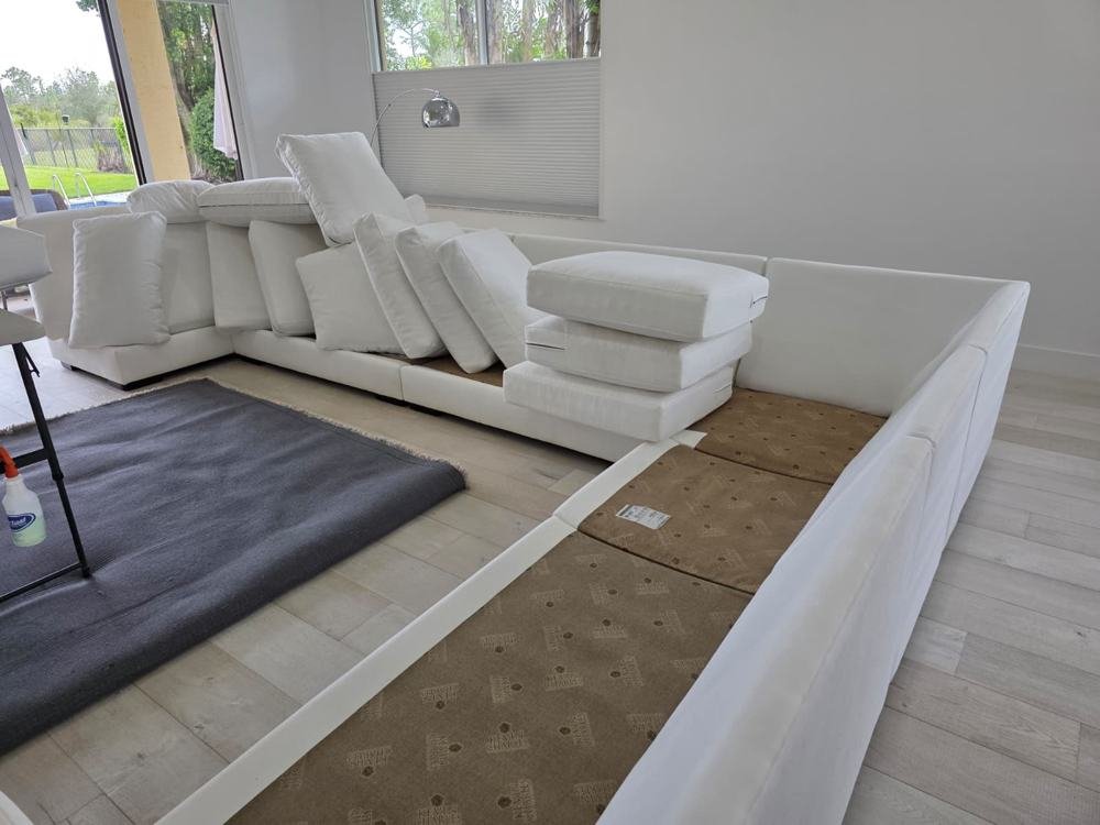 White modular sofa with cushions removed for upholstery cleaning