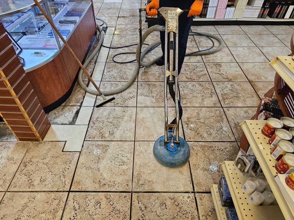 Store tile floor being cleaned with a rotary tile cleaning tool