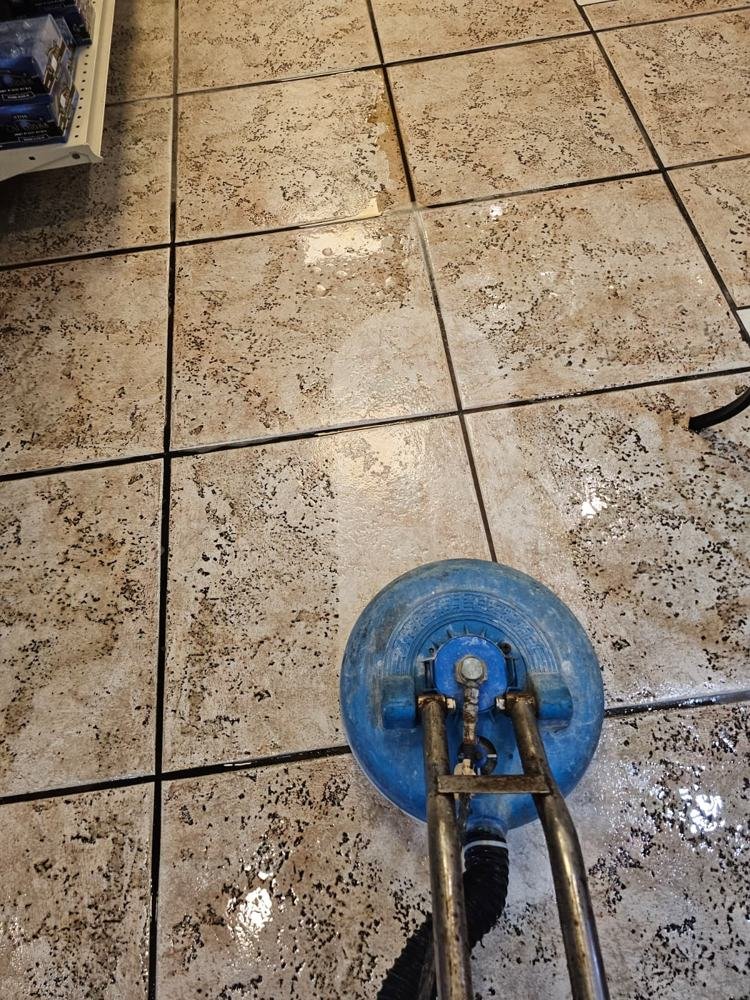 Tile and grout cleaning in progress on a patterned floor