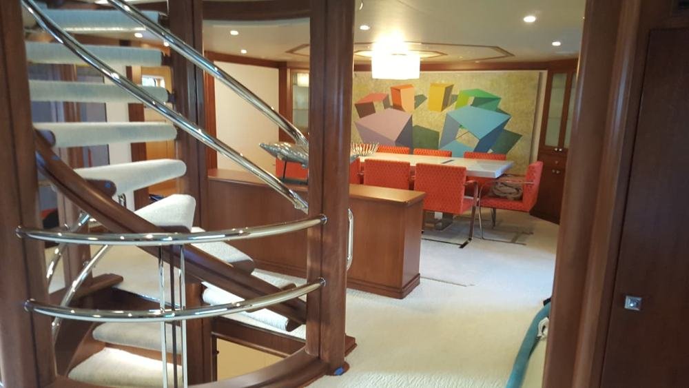 Yacht spiral staircase and white carpet interior