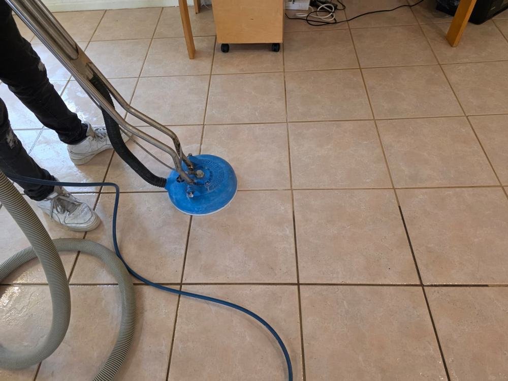Rotary machine cleaning a ceramic tile floor
