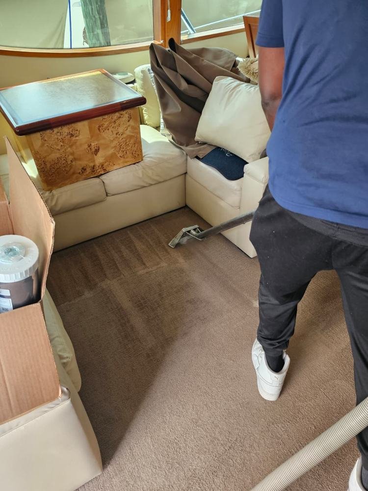 Technician extracting yacht salon carpet
