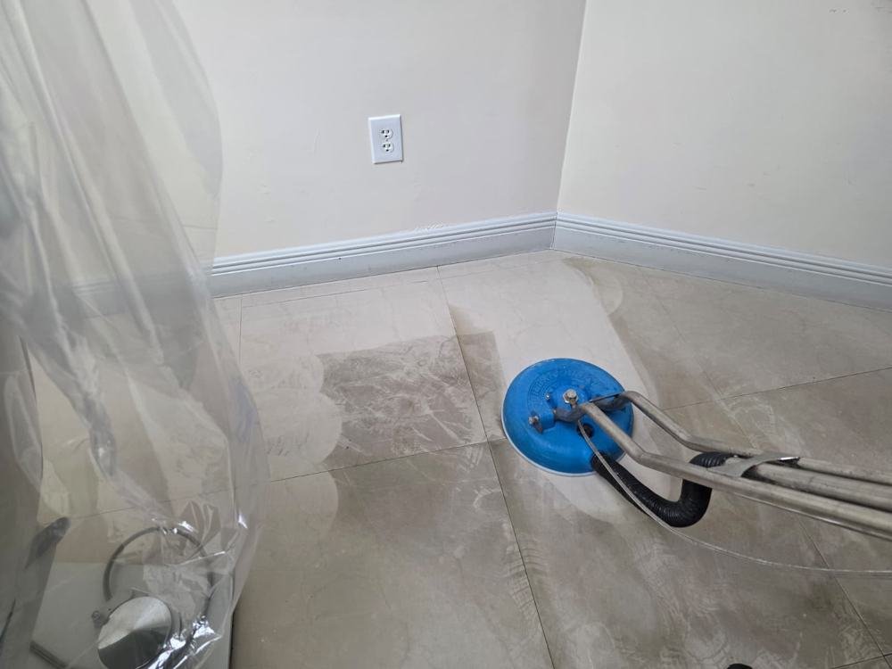 Tile floor being cleaned with a rotary extraction tool