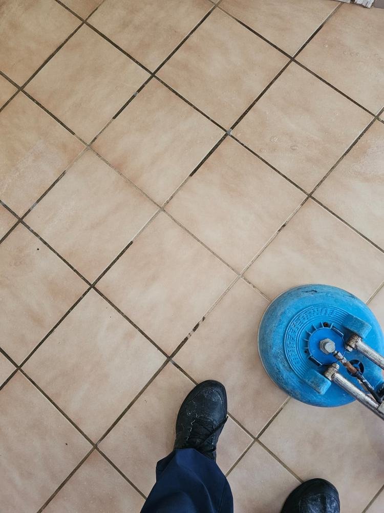 Grout lines being cleaned on a diagonal tile floor