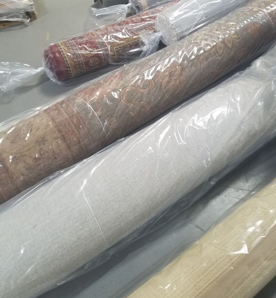 Cleaned area rugs wrapped in plastic for delivery